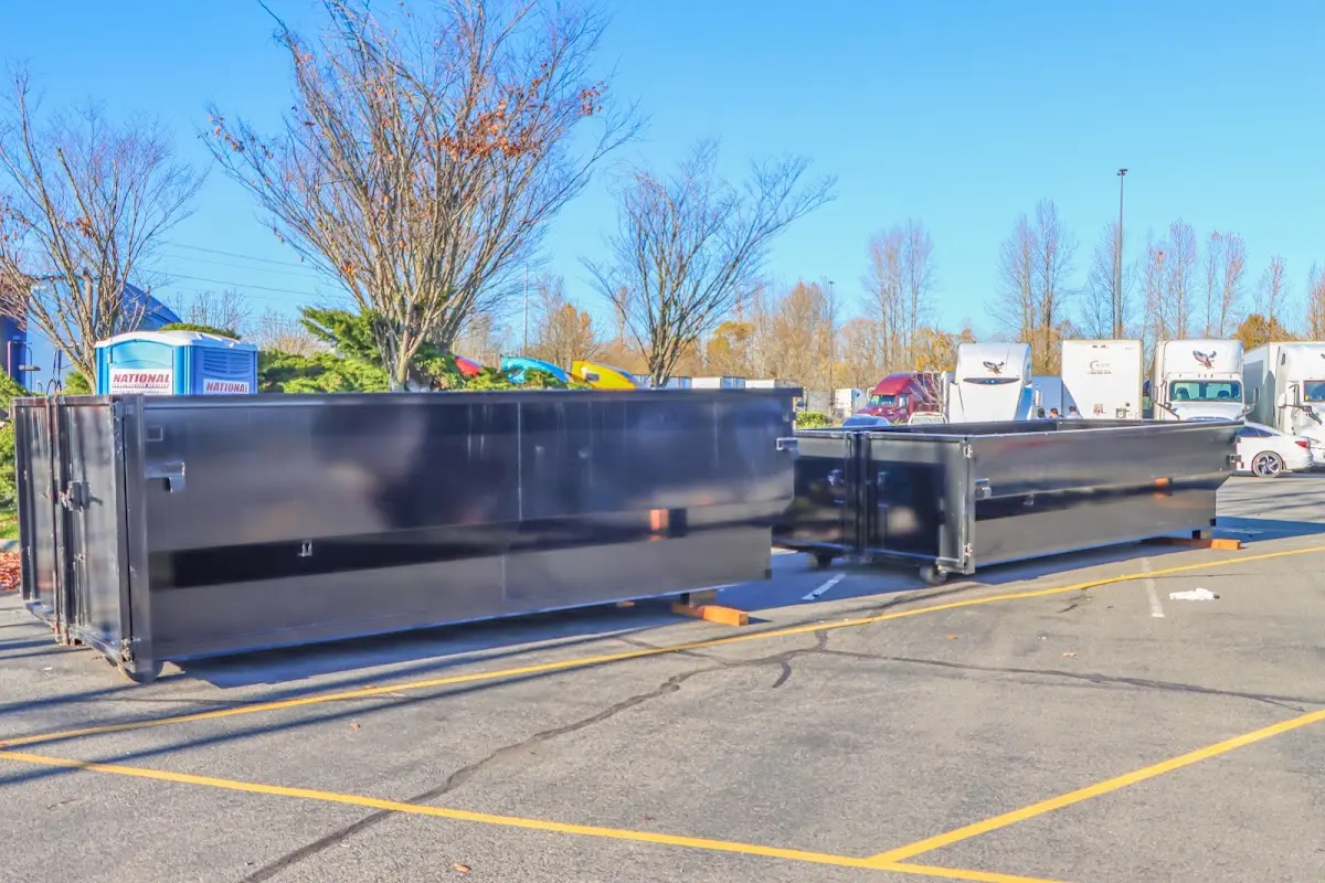 Professional dumpster rental service with roll-off container on residential driveway in Seneca Falls